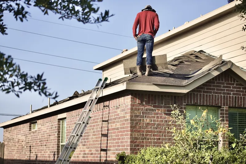 Professional roofer working on a residential roof in Stagecoach Trail
